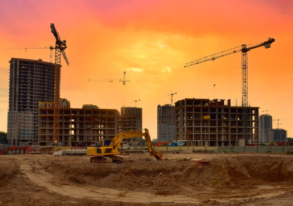 Backhoe digging ground for foundation pit