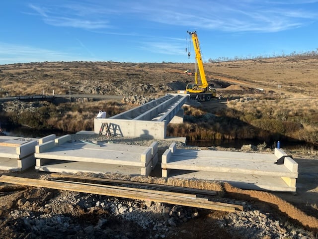 Crane installing concrete bridge beams at Port Phillip Bridge project by South East Civil & Crane.