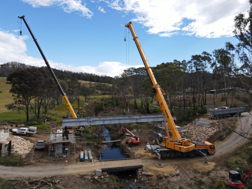 Cranes lifting steel bridge girders during construction at Pretty Point Bridge by South East Civil & Crane.