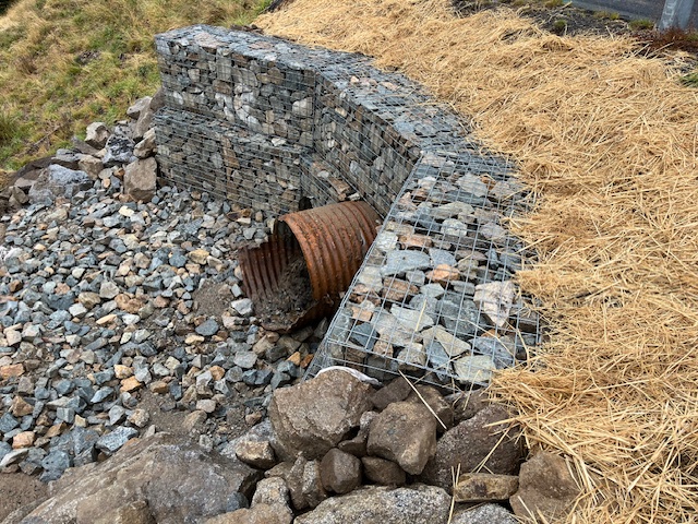 gabion basket retaining wall installed for erosion control around a culvert outlet on guthega rd