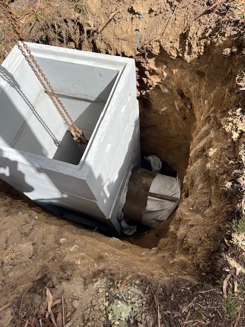 lowering a precast concrete stormwater pit into position for the guthega rd drainage system