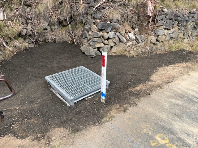new roadside stormwater drainage pit with a galvanised steel grate, installed as part of the guthe