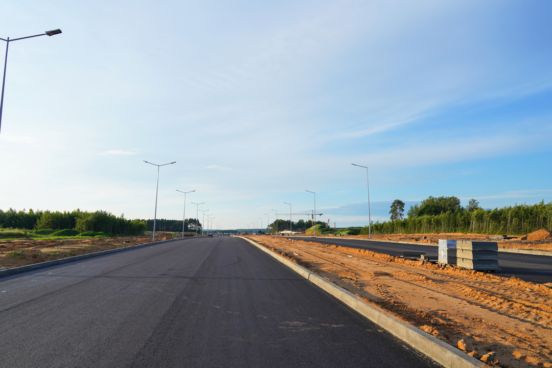 Freshly paved road with streetlights after civil construction by South East Civil & Crane.